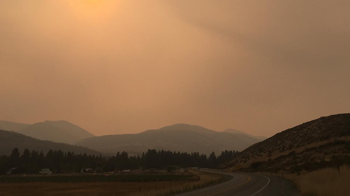 Smoky skies reduce visibility along a road in central Washington.