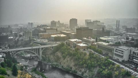 Smoky skies over the buildings, bridges and river of Spokane, Washington.