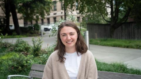 Claire Schollaert sits on a bench on the UW campus.