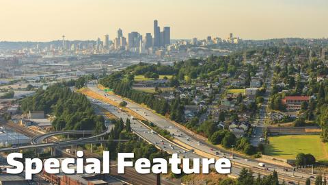 The Seattle skyline on a foggy or smokey day with the freeway leading into it