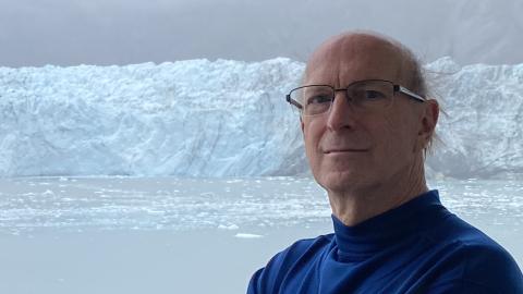 Close-up of David Eaton in front of a glacier.