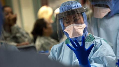 Lady pulling on rubber glove