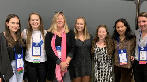 A group of students and faculty pose for a photo.