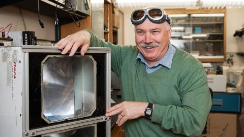 Photo of Mike Yost tinkering in the lab.