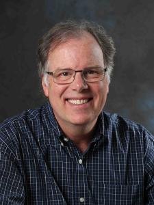 Headshot of Jerry who is an older white man with salt and pepper hair