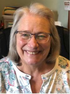 Aileen, an older white woman with medium-length gray hair and glasses