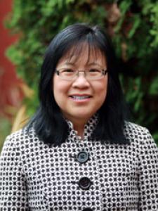 Dr Mar, a middle-aged Asian woman with shoulder length hair and fringe, with clear glasses