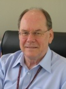 Headshot of Dr Hoff, an older, bespectacled balding white man with salt and pepper hair and a mustache