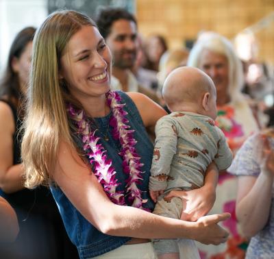 Rebecca Kann smiles holding her baby.