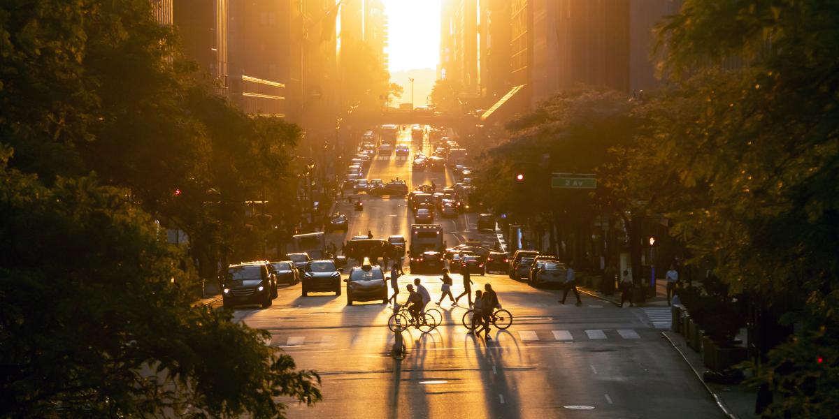 sun setting over busy city intersection