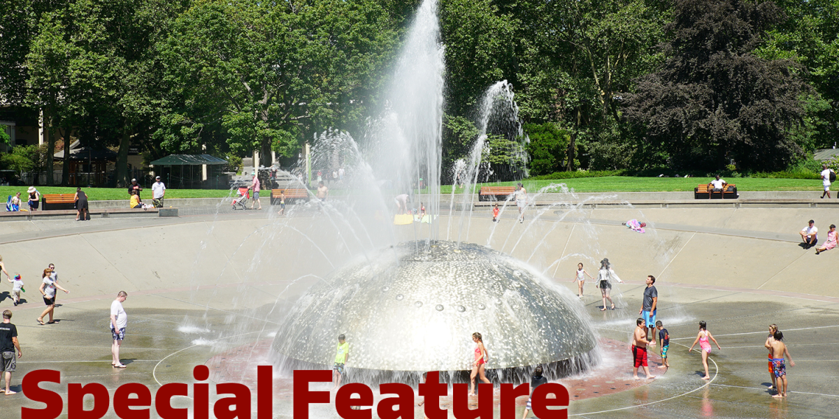 Families paying in fountain with the words 'Special Feature' over the top. 