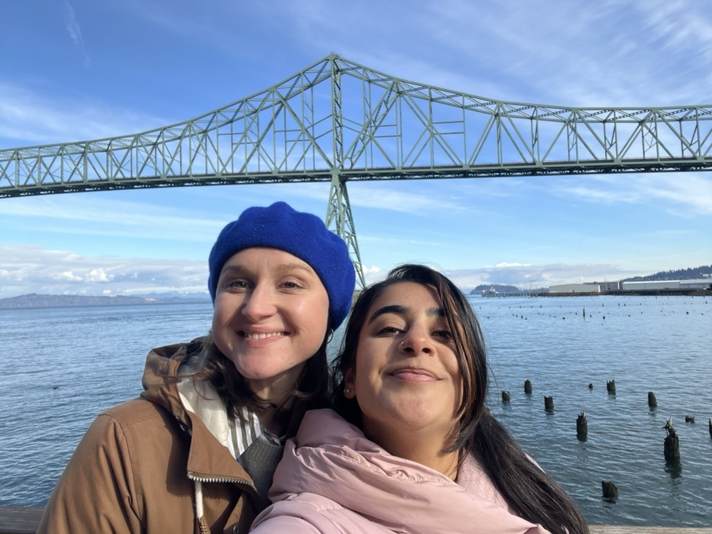 Maja Jeranko and Amber Khan pose in front of a bridge and waterway.