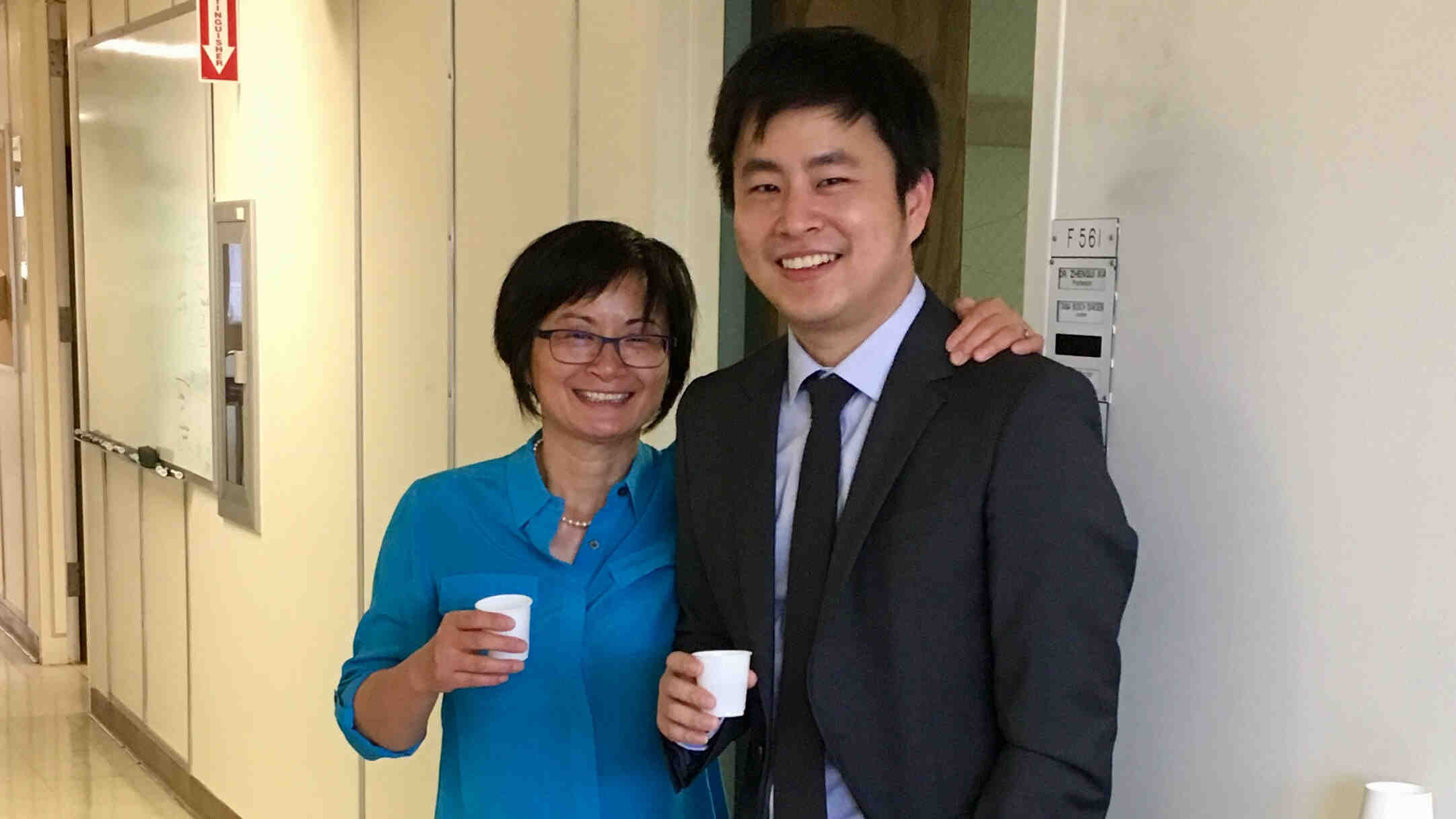 Zhengui Xia and Hao Wang pose together after his dissertation defense