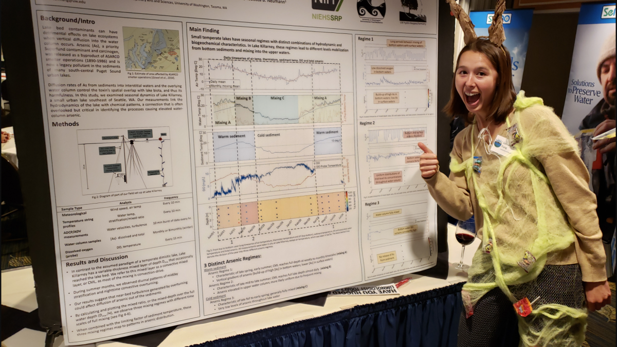 Samantha Fung is dressed as a snail in a food web and standing in front of her poster on the vertical mixing of arsenic from lakebed sediments.