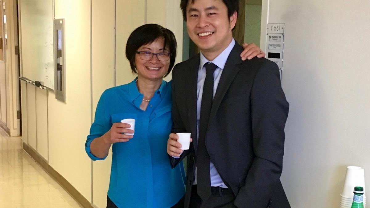 Dr. Wand stands in a hallway with his Ph.D. advisor, Dr. Zhengui Xia