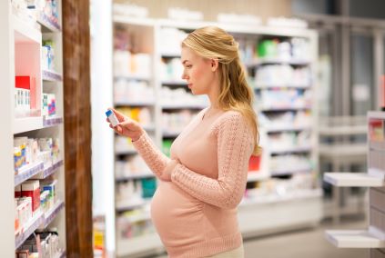 woman looking at medication